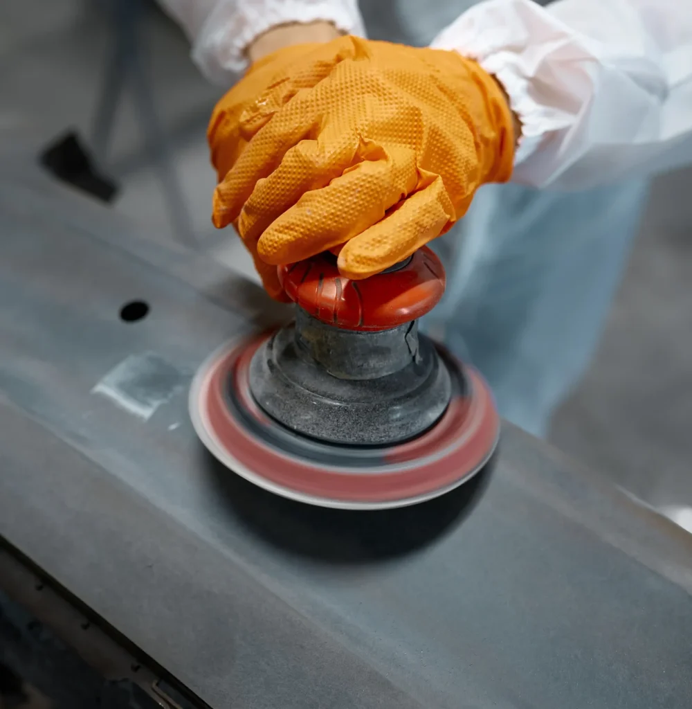 repair-work-orange-gloves-smoothing-the-car-bumpe-2026-03-17-03-35-38-utc